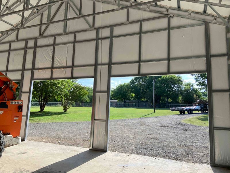 the inside of a garage with a metal frame and white walls .