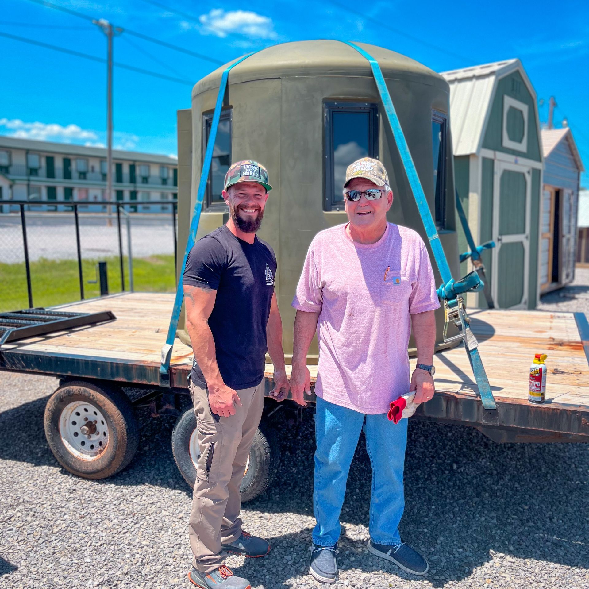 two men standing in front of a trailer with two phantom blinds on there 
