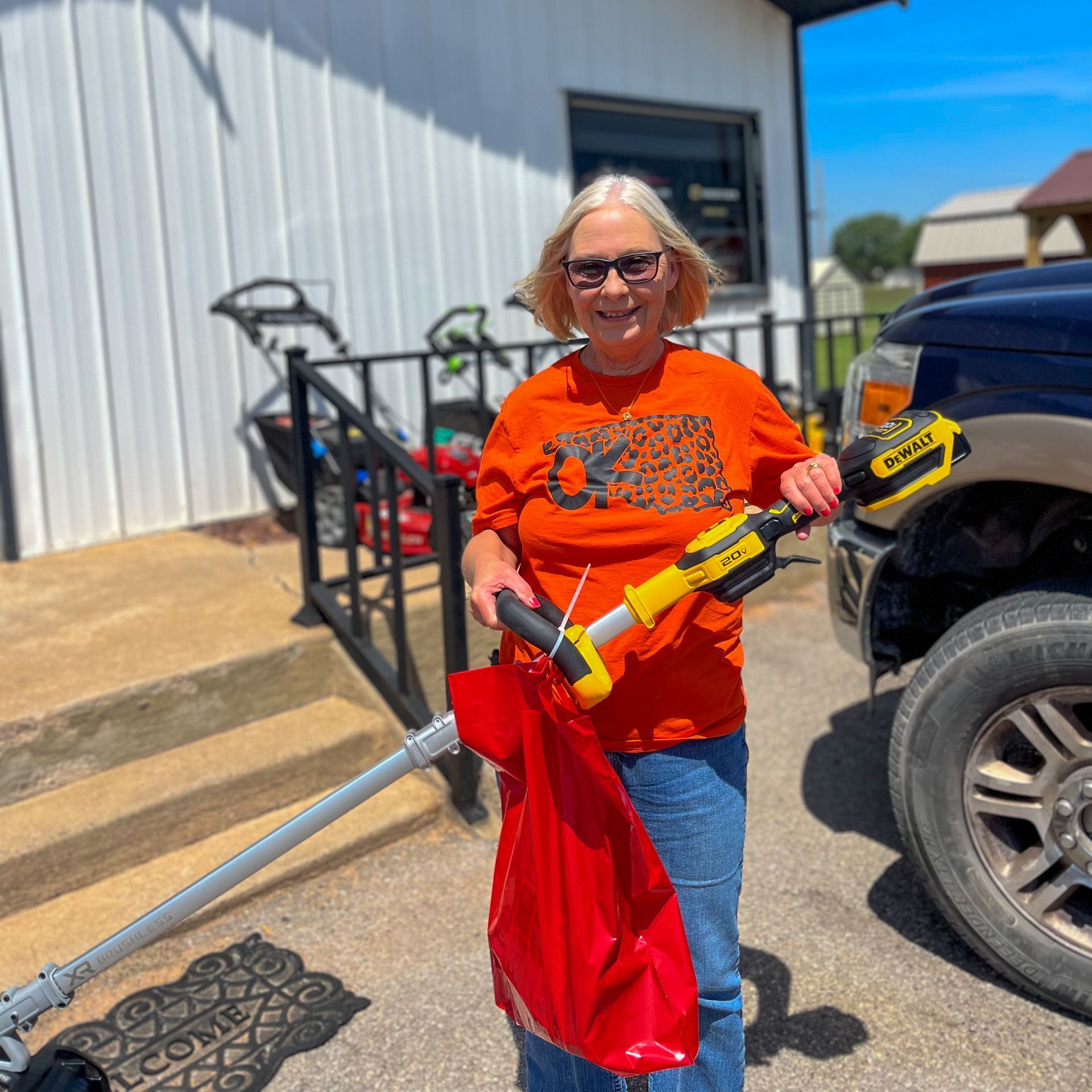 Customer with handheld DeWalt trimmer