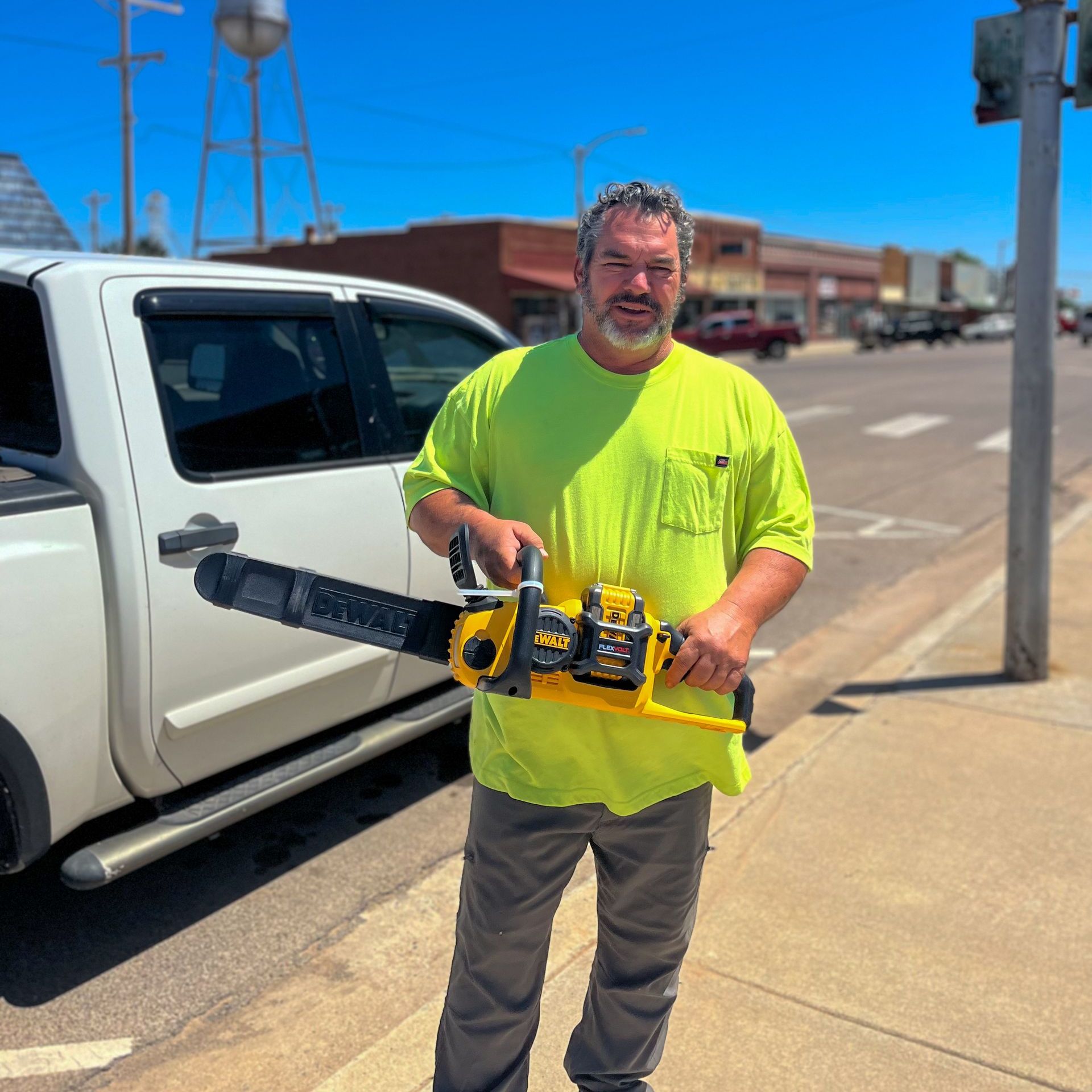 Customer with handheld Dewalt Chainsaw