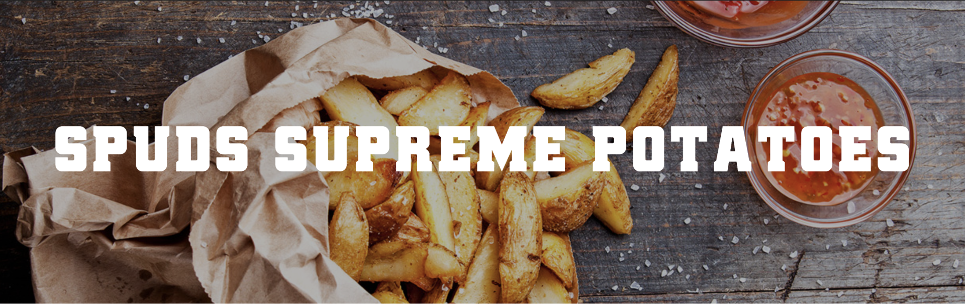 A bag of spuds supreme potatoes is on a wooden table.