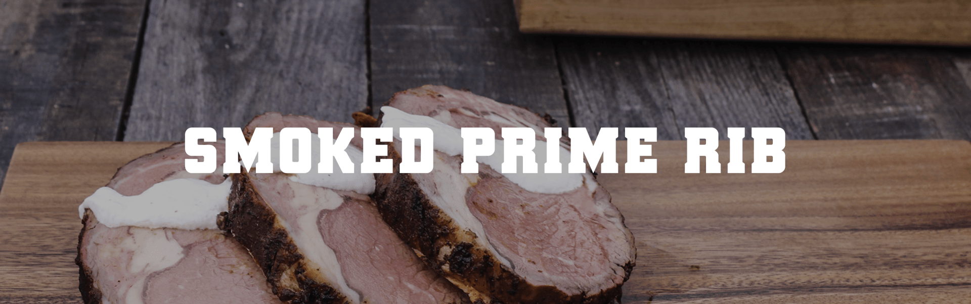 A smoked prime rib is sitting on a wooden cutting board.