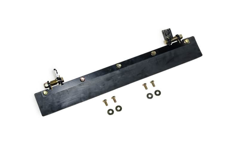 A black rubber blade with screws attached to it on a white background.