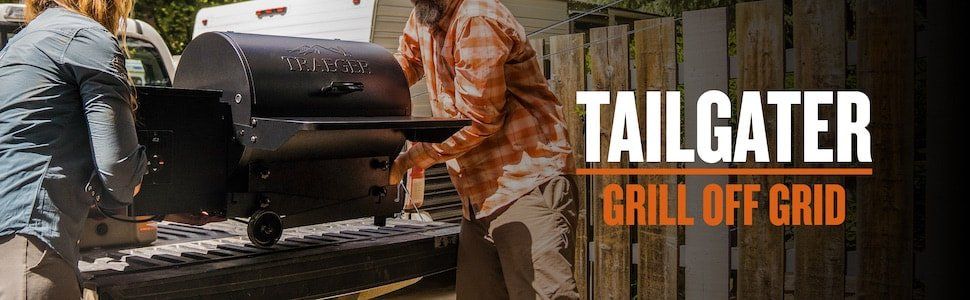 A man and a woman are standing next to a tailgate grill.