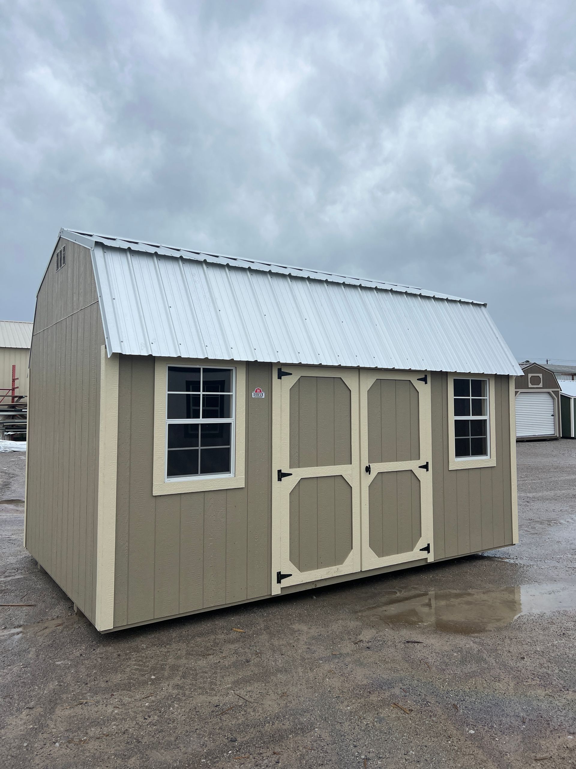 Explore the Derksen Best Value Wood Side Lofted Barn 10x16, featuring Taupe paint and Galvalume roof. Perfect for storage or a workshop!