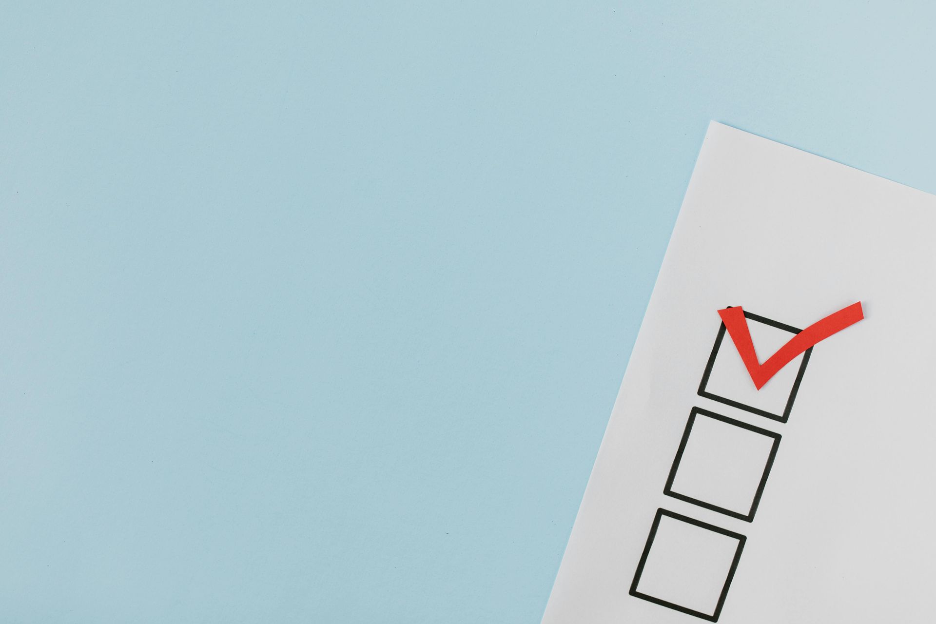 Red check mark on a checkbox list on a white form against a light blue background