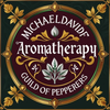 Maroon and gold ornamental badge reading &ldquo;Michael David Aromatherapy&rdquo; and &ldquo;Guild of Pepperers&rdquo; with floral motifs