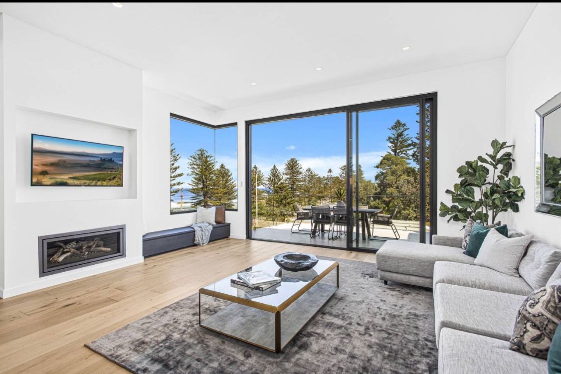 A Living Room with a Couch and a TV— LG Constructions in Thirroul, NSW