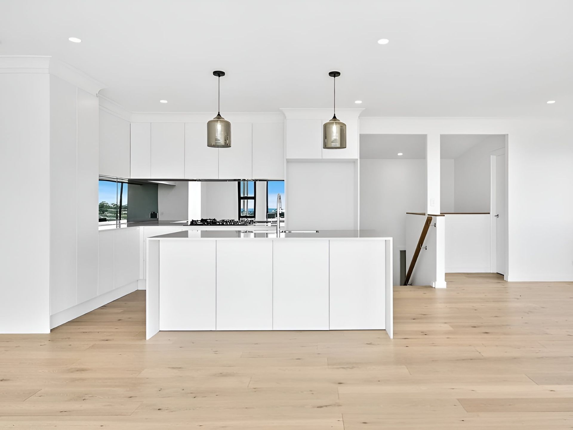 A Kitchen With White Cabinets and a Large Island — LG Constructions in Thirroul, NSW