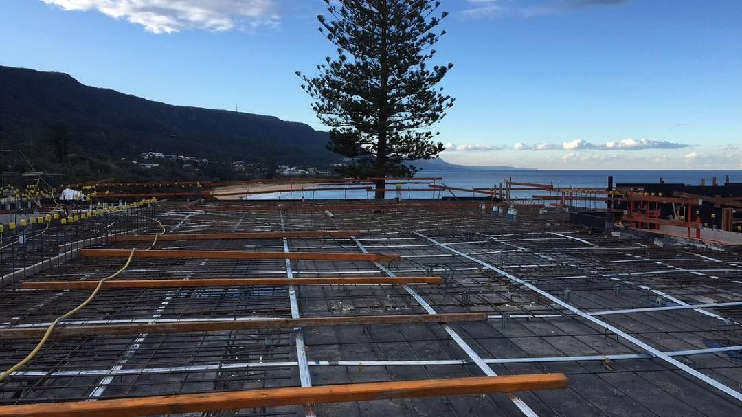 A Construction Site With a View of the Ocean and Mountains in the Background — LG Constructions in Thirroul, NSW