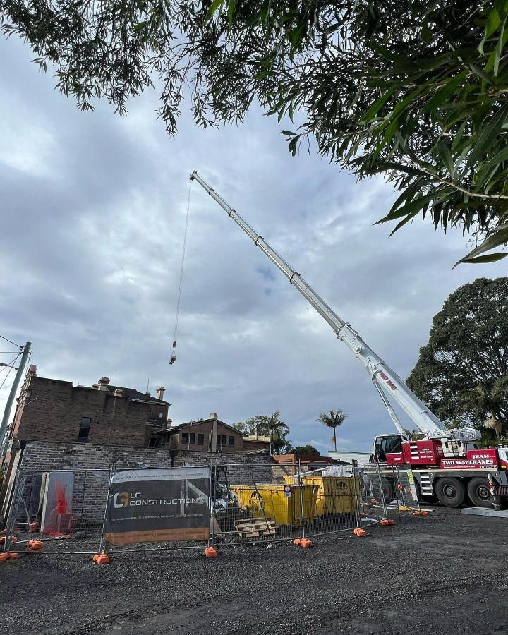 A Large Crane is Sitting on Top of a Construction Site — LG Constructions in Thirroul, NSW