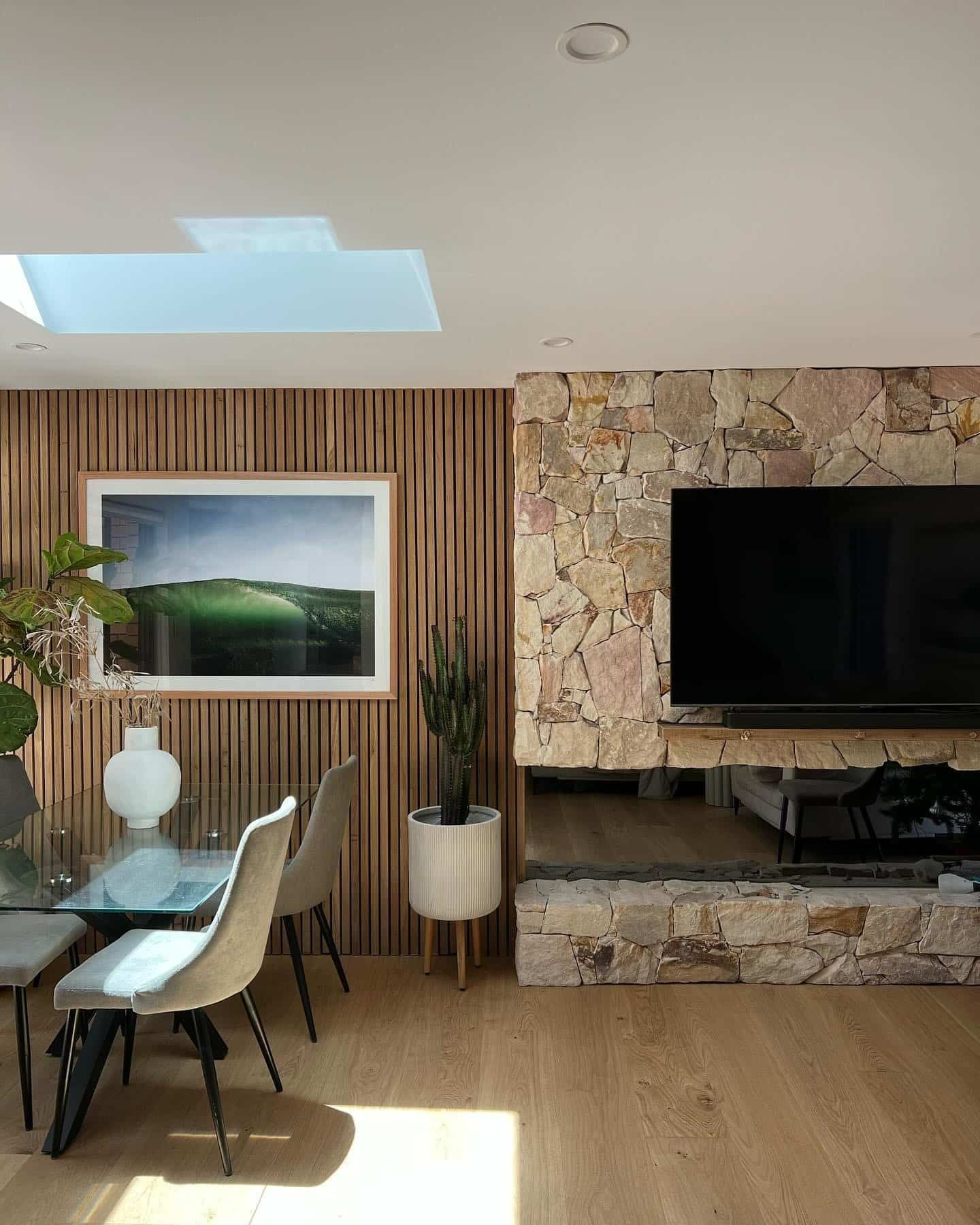 A Living Room With a Table and Chairs and a Flat Screen TV — LG Constructions in Thirroul, NSW