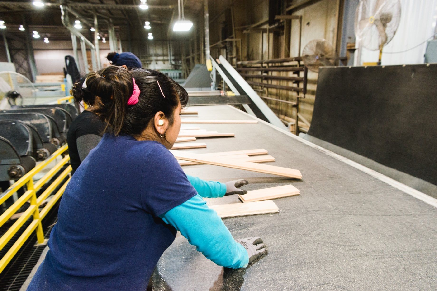 Lumber workers sorting wood
