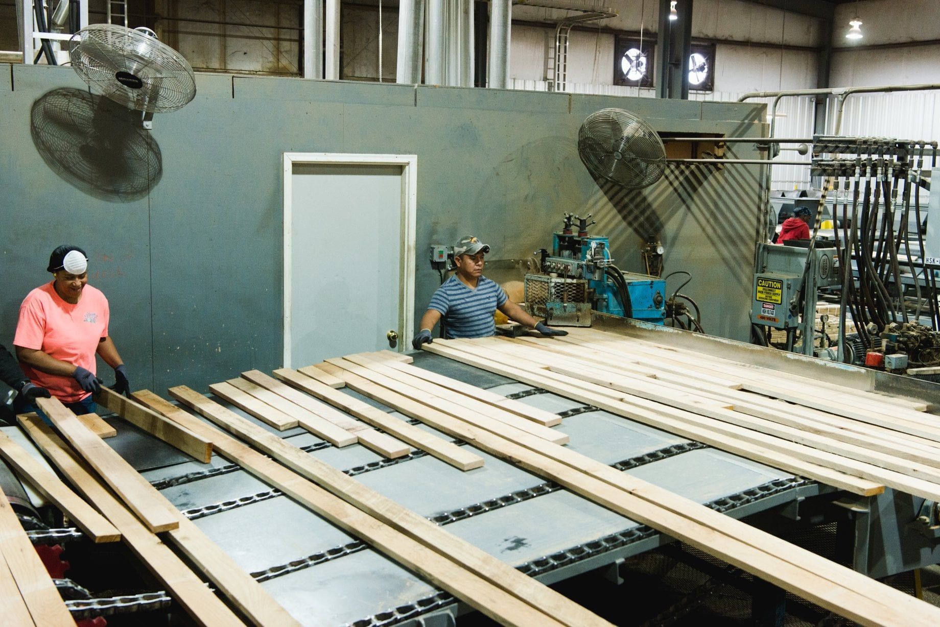 Lumber workers sorting wood