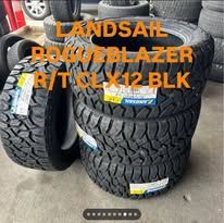 Set of black LandSail off-road tires, R/T, TCL X12 BLK, displayed outdoors.