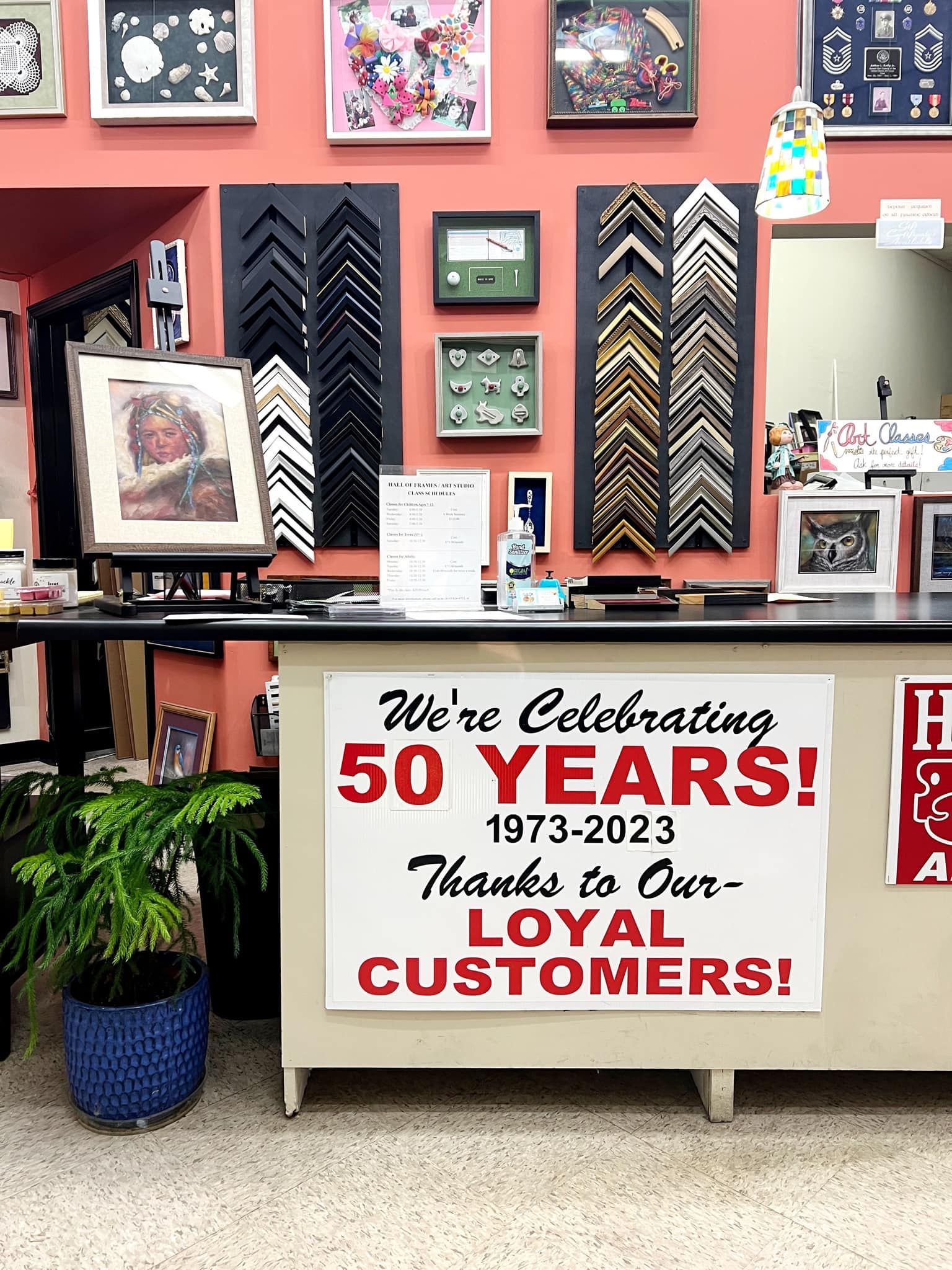Store display celebrating 50 years, with framed art, decor, and a “We’re Celebrating 50 YEARS” sign.