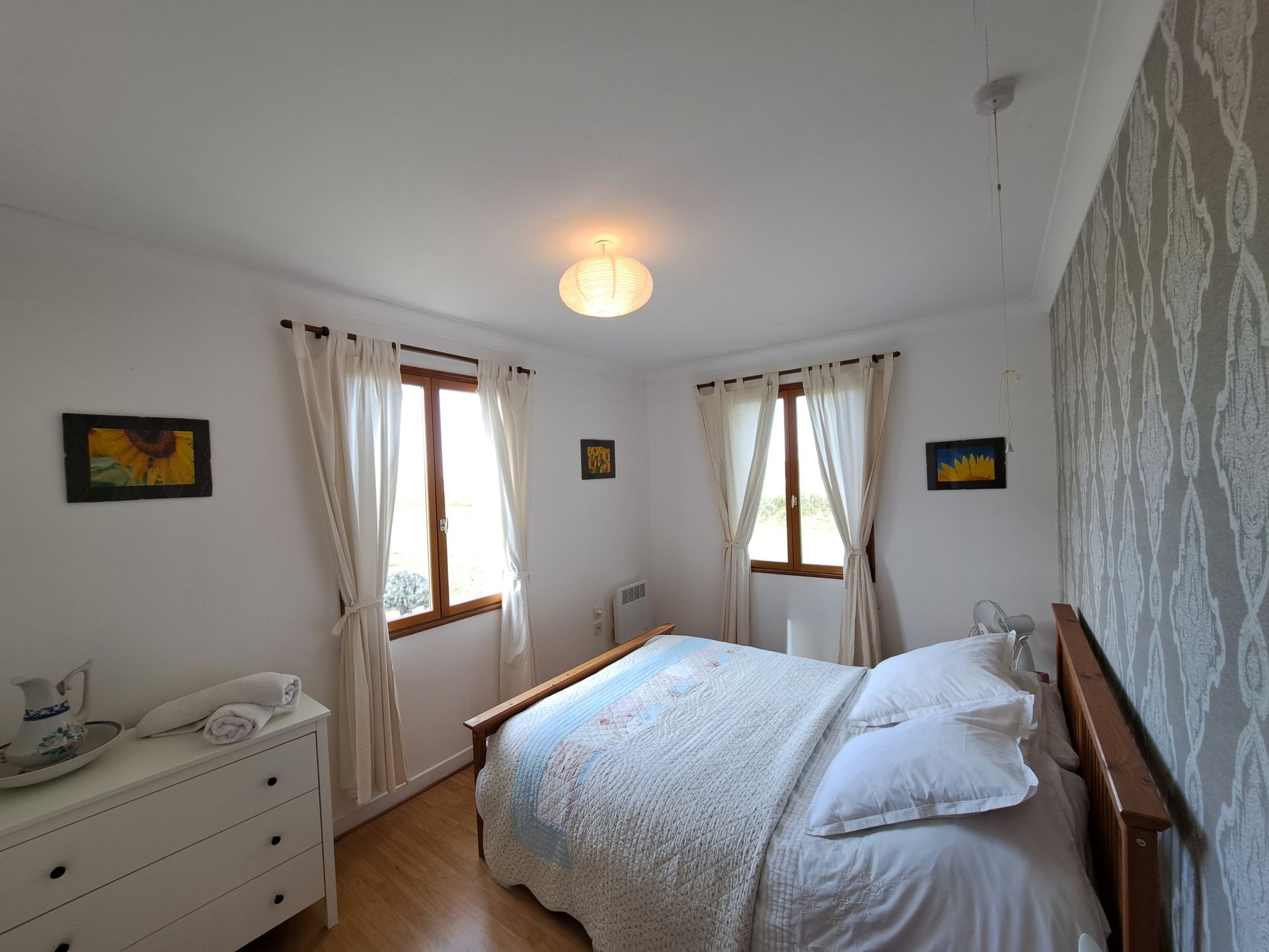 bedroom with large bed and white bedlinen