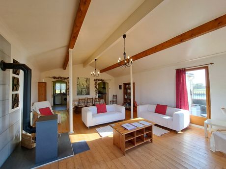 sitting room with vaulted ceiling and white ikea sofas with red cushions