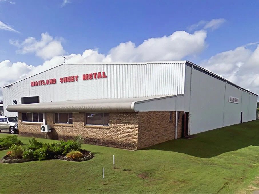 A Large White Building with The Word Metal on It — Maitland Sheet Metal in Rutherford, NSW