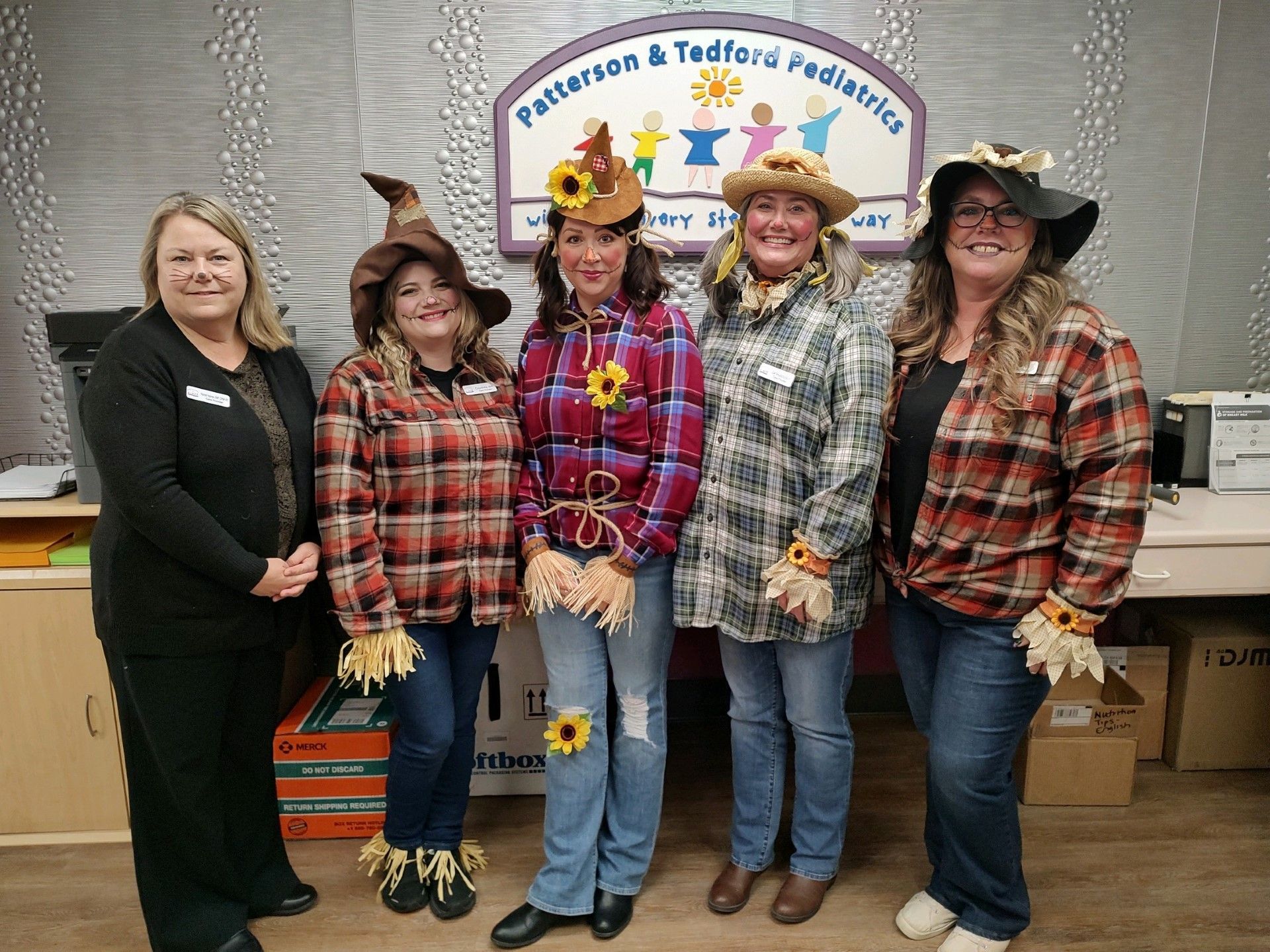 A group of women dressed as scarecrows are posing for a picture.