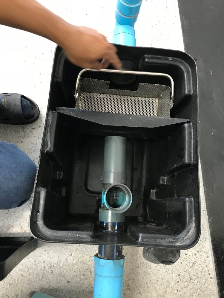 A Person Is Working On A Pipe In A Box — All Hours Vac Truck In Yeppoon, QLD