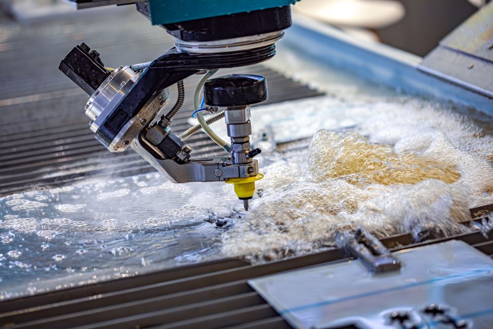A Machine Is Cutting A Piece Of Metal With Water — All Hours Vac Truck In Lakes Creek, QLD