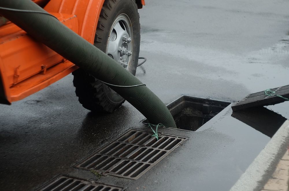A Truck Is Pumping Water Into A Manhole Cover — All Hours Vac Truck In Rockhampton, QLD