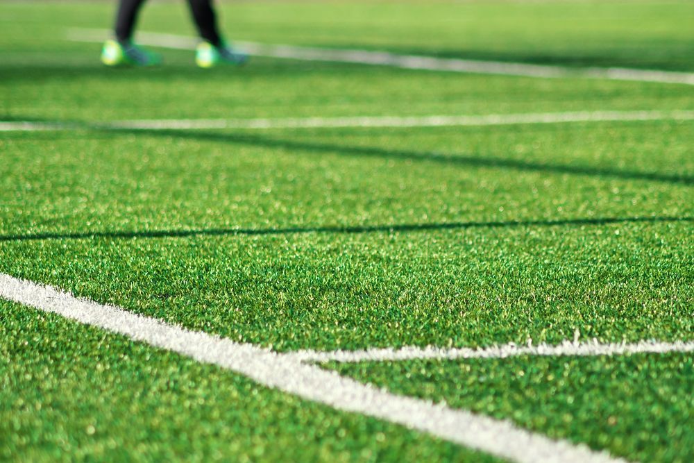 A Close Up Of A Soccer Field With A White Line On It — All Hours Vac Truck In Lakes Creek, QLD