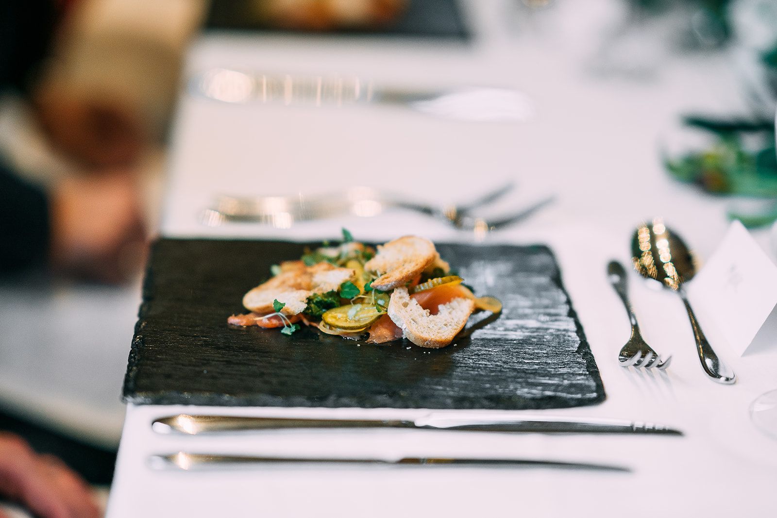 A plate of food is sitting on a table with silverware.