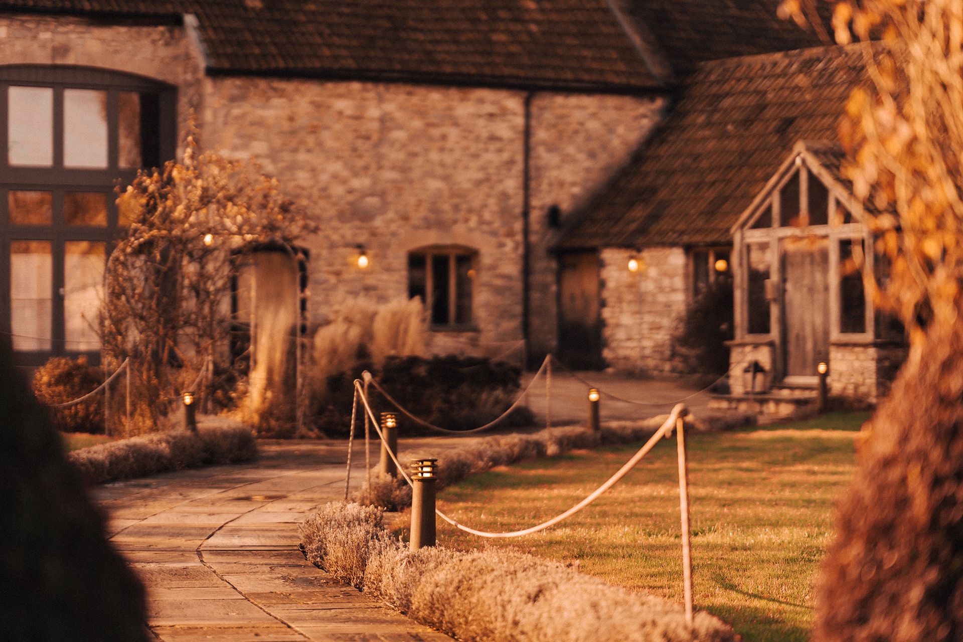 A stone building with a rope fence in front of it.