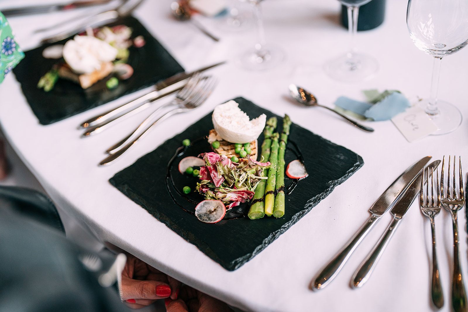 A table with plates of food and silverware on it.