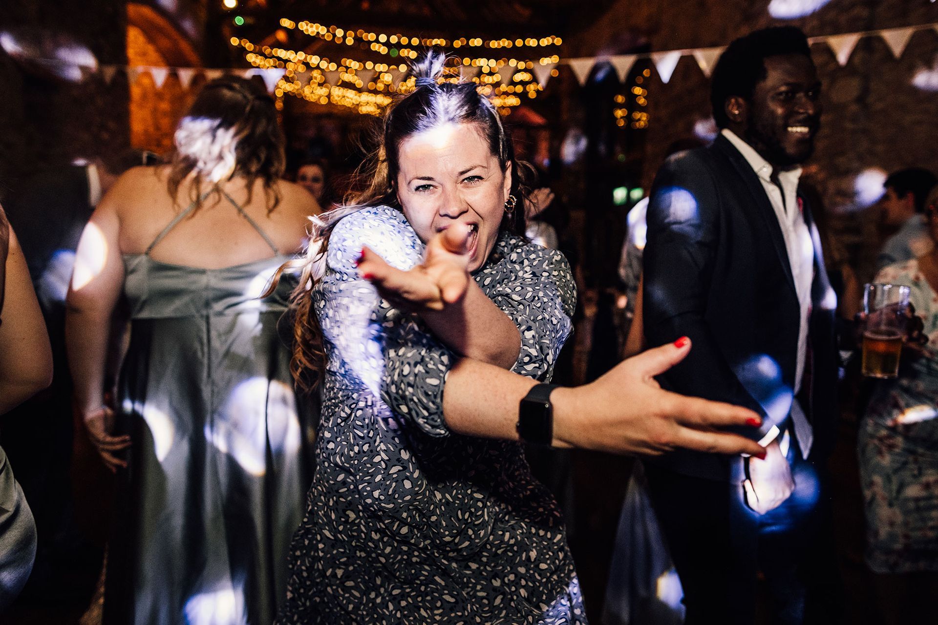 A woman is dancing in a crowd of people at a party.
