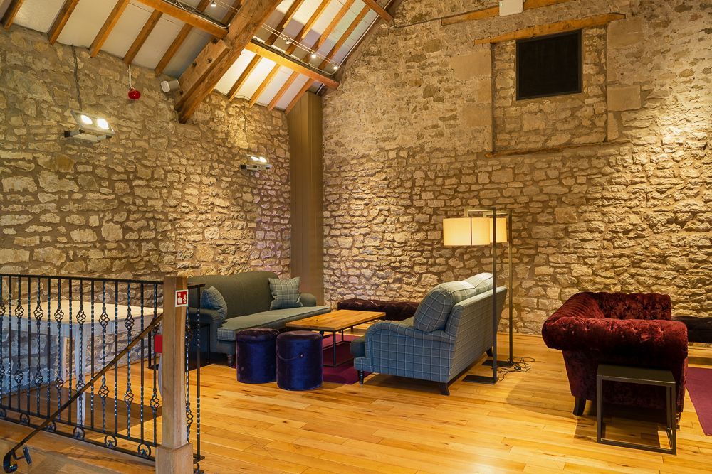 A living room filled with furniture and a brick wall.