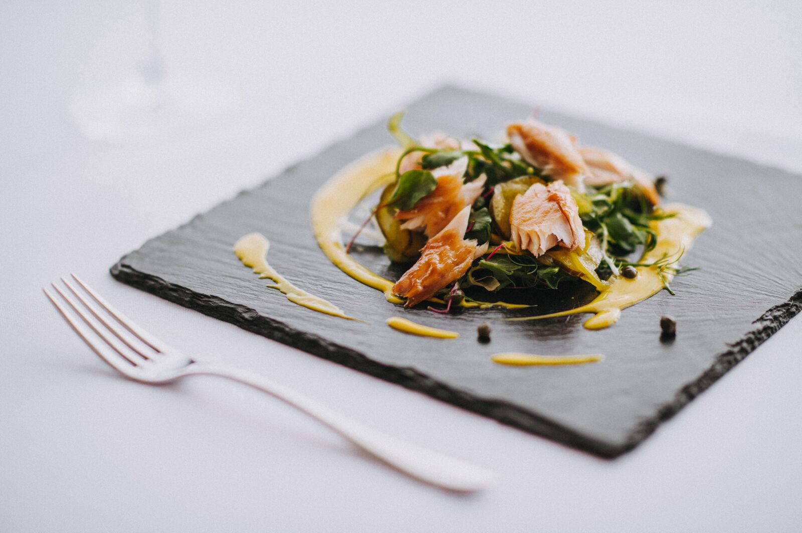 A plate of food with a fork on a table.