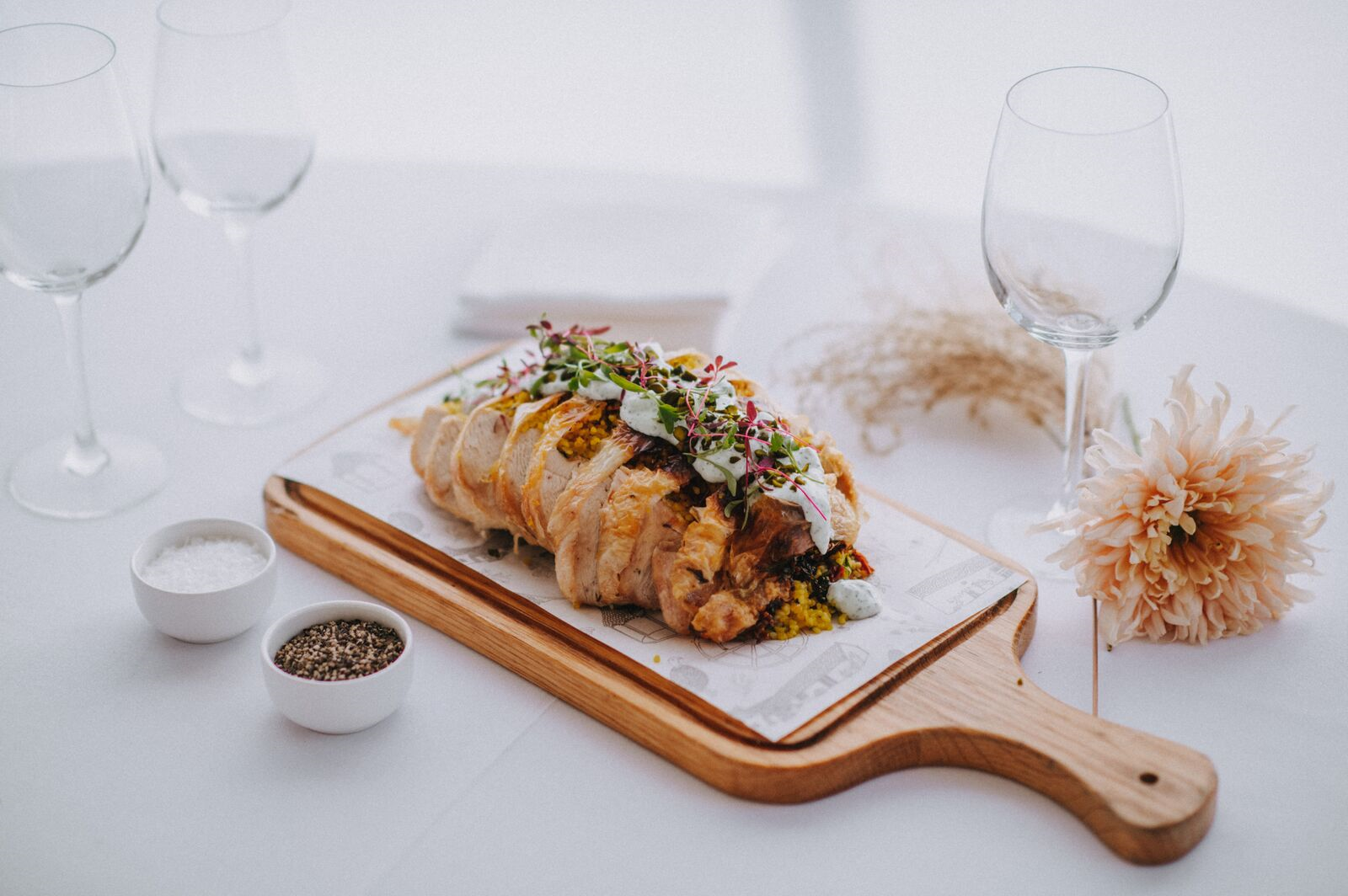 A wooden cutting board with a piece of food on it on a table.