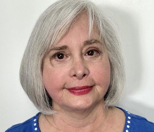Woman with grey hair and blue shirt