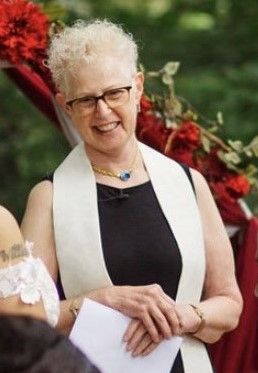 woman priest smiling at wedding