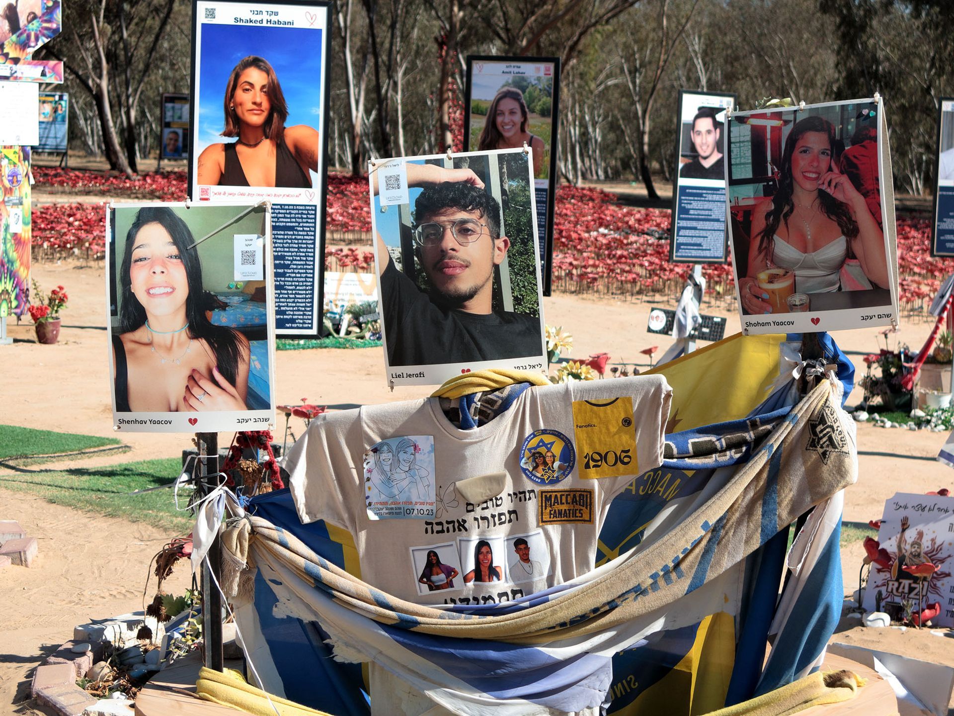 Photos of 6 Israelis and other mementos at the Nova Music Festival memorial site near Reím, Israel.