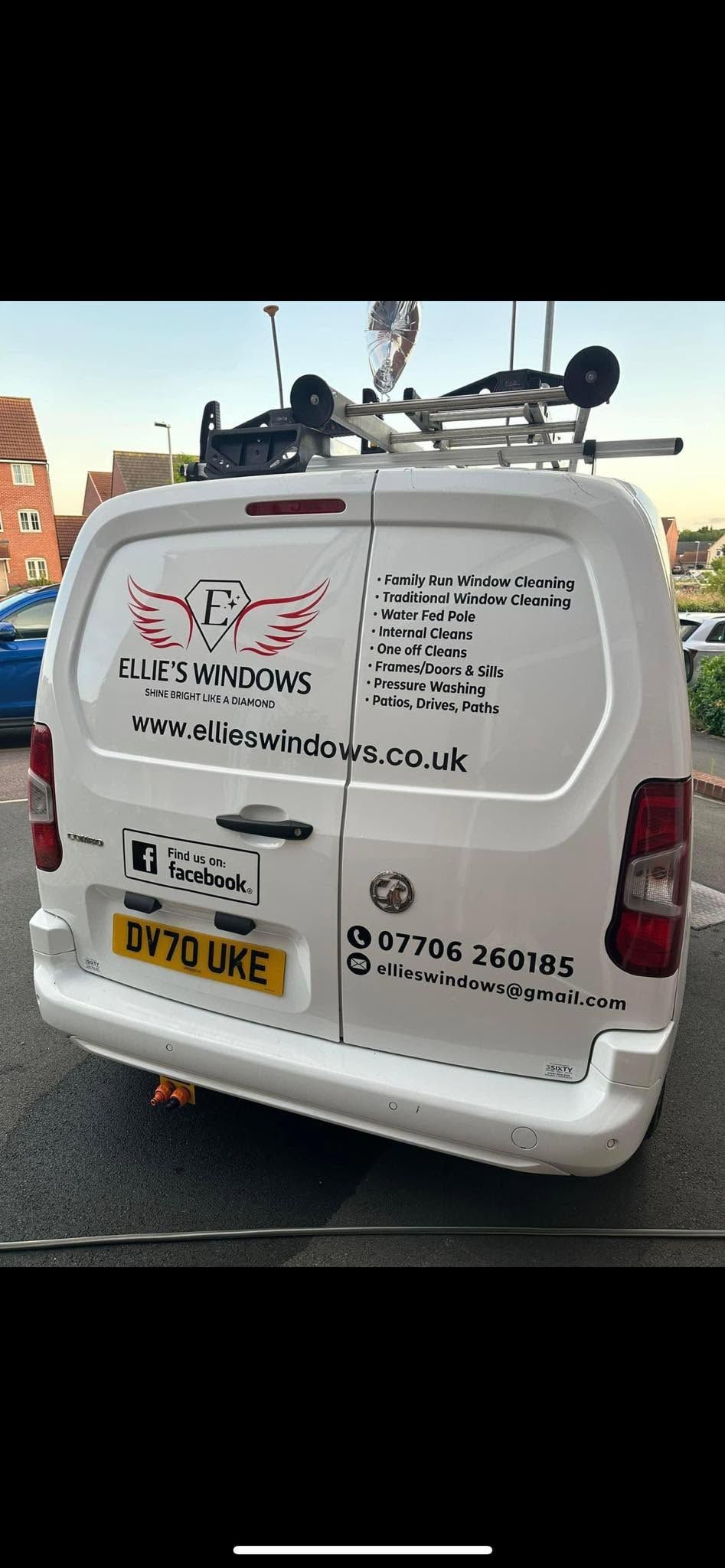 Ellie's Windows Van with graphics and license plate, parked on a street in daylight.