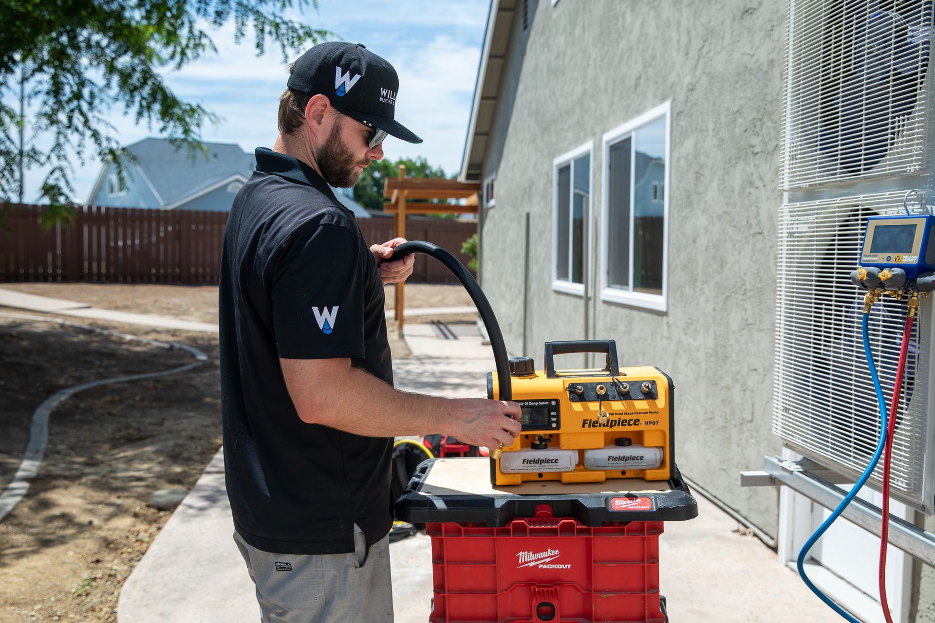 Williams Mechanical Co HVAC technician setting up a Fieldpiece vacuum pump.