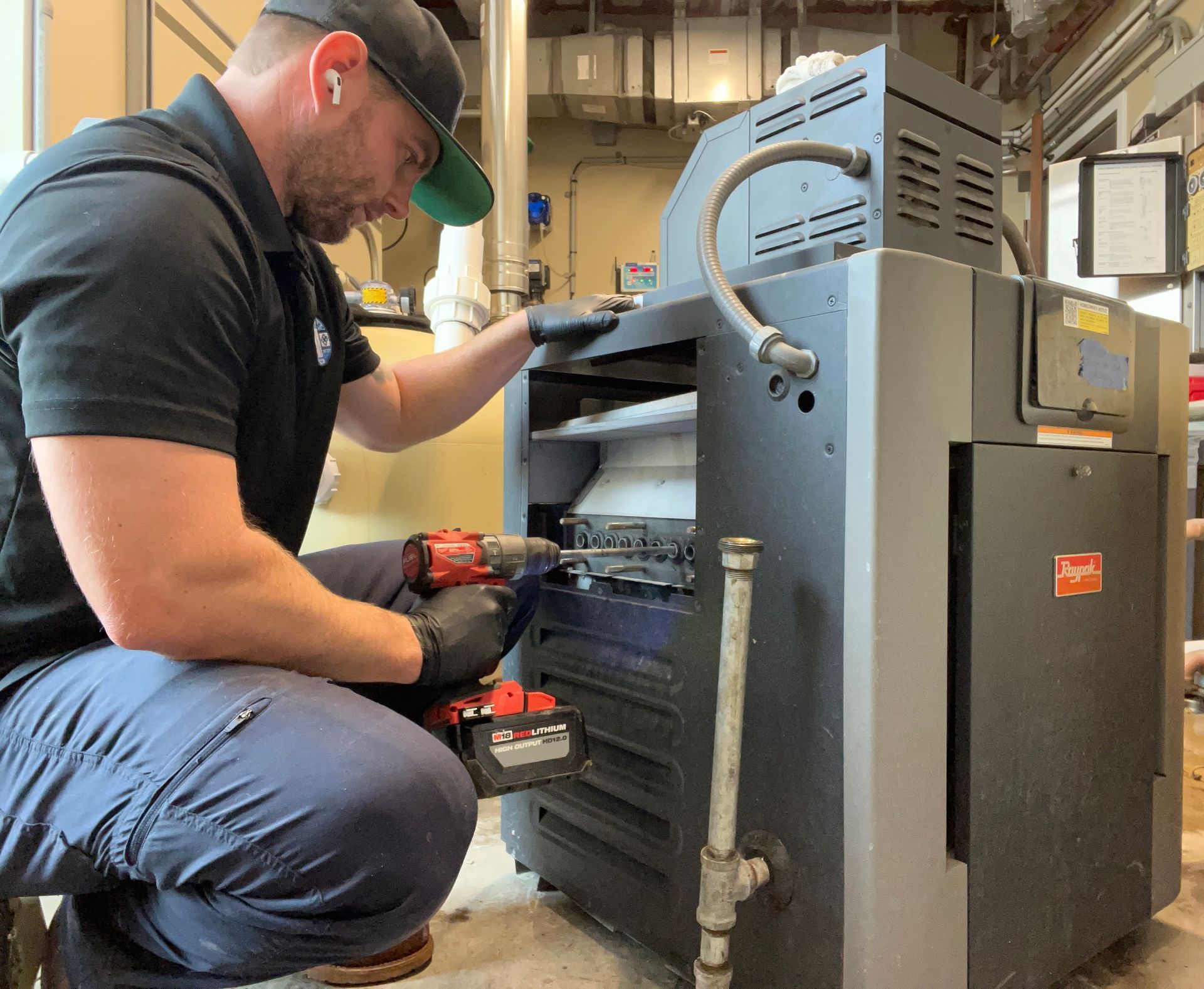 Williams Mechanical Co HVAC technician servicing a commercial Raypak boiler.