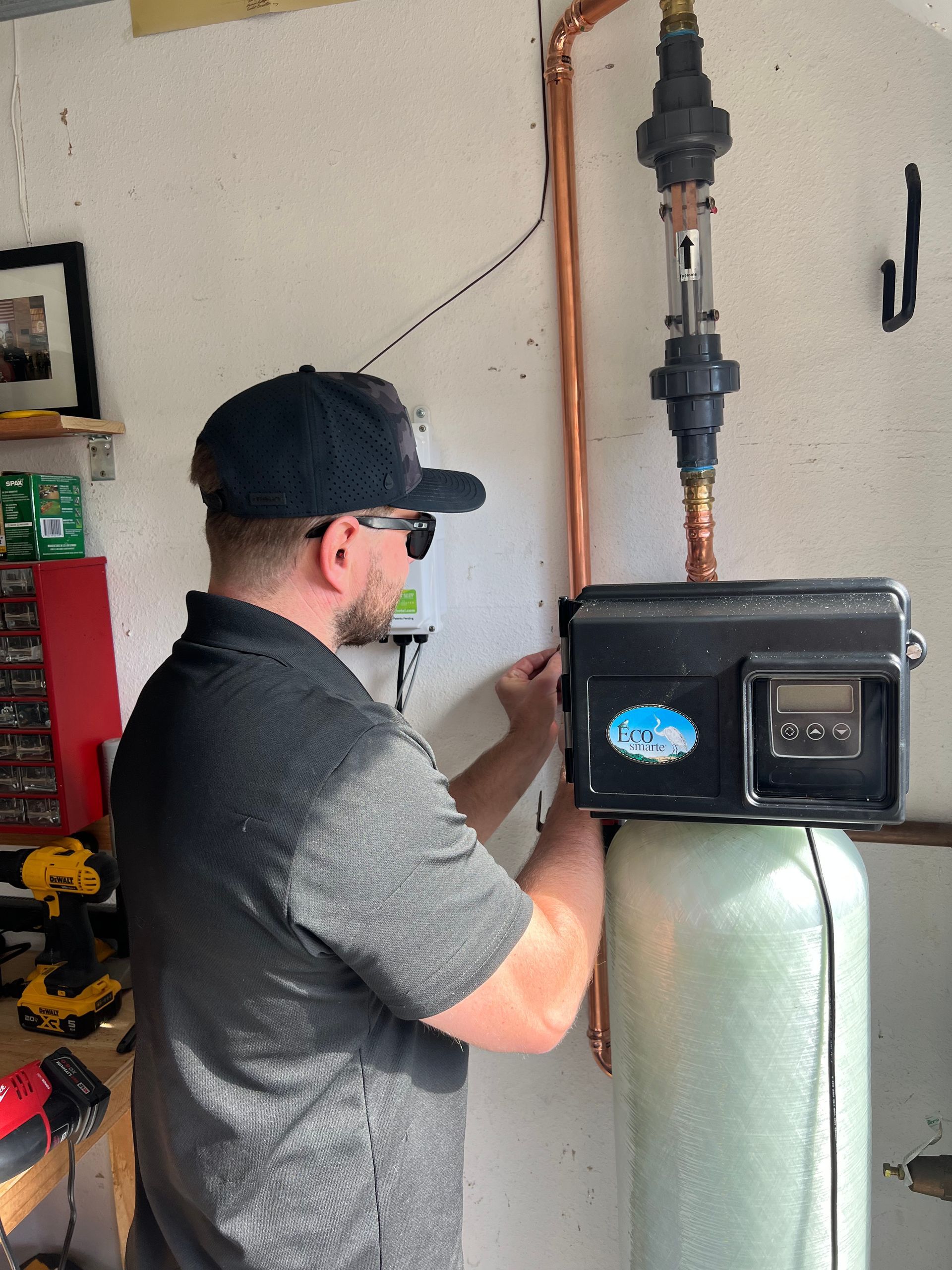 Williams Mechanical Co technician installing a water filtration system