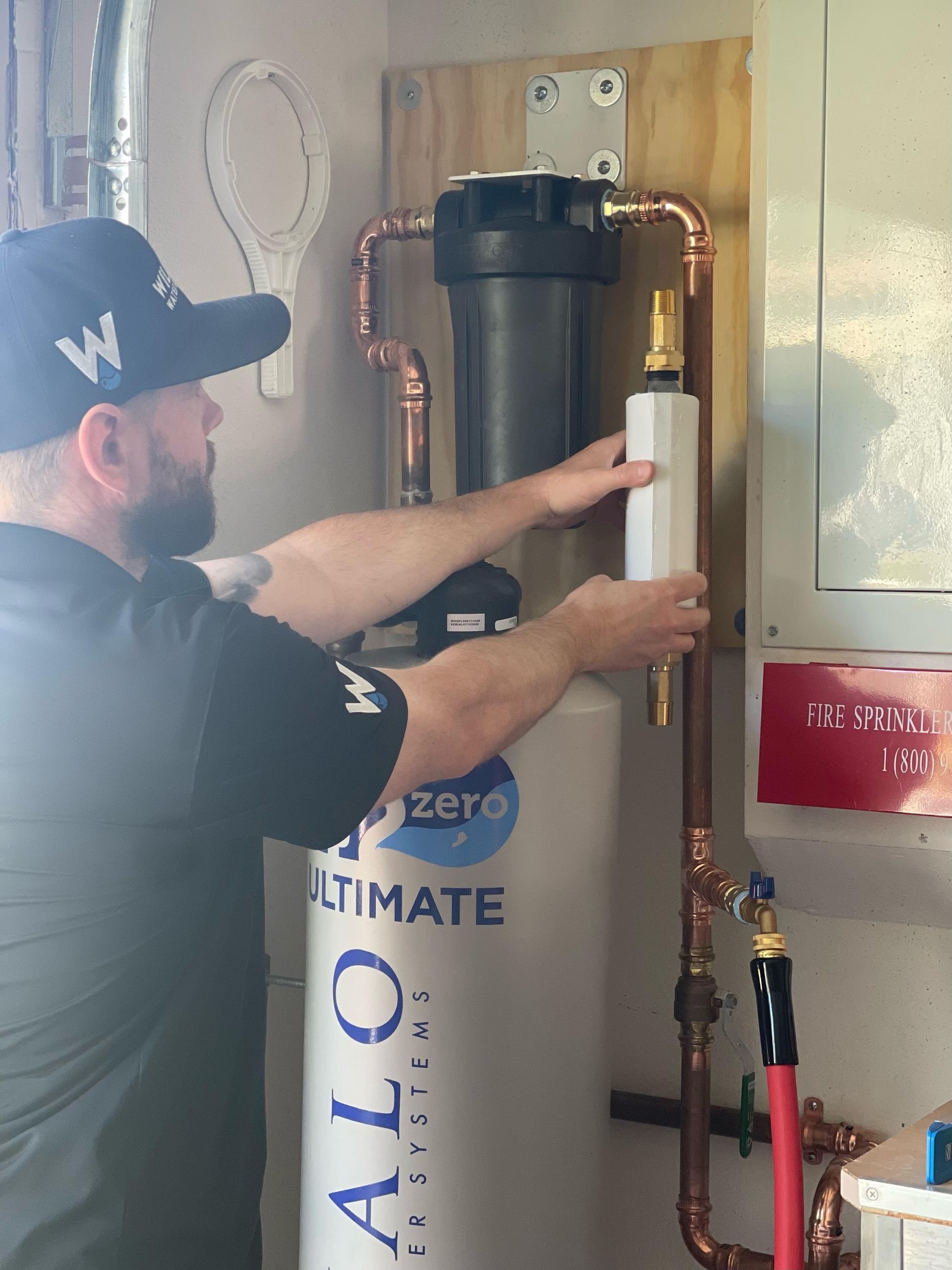 Williams Mechanical Co technician installing a Kohler H2Wise and Moen Flo leak detector.