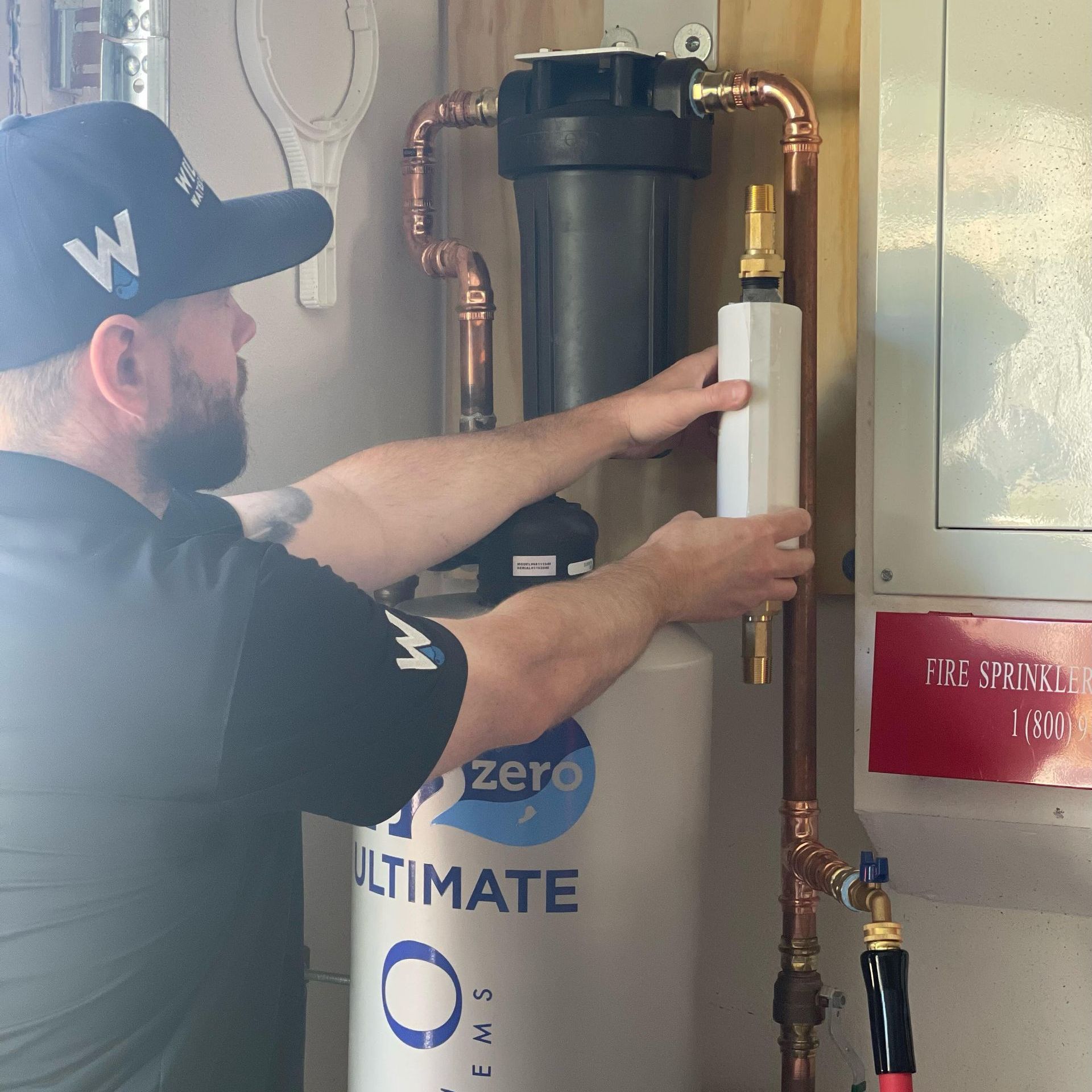 Williams Mechanical Co technician installing a Kohler H2Wise and Moen Flo leak detector.