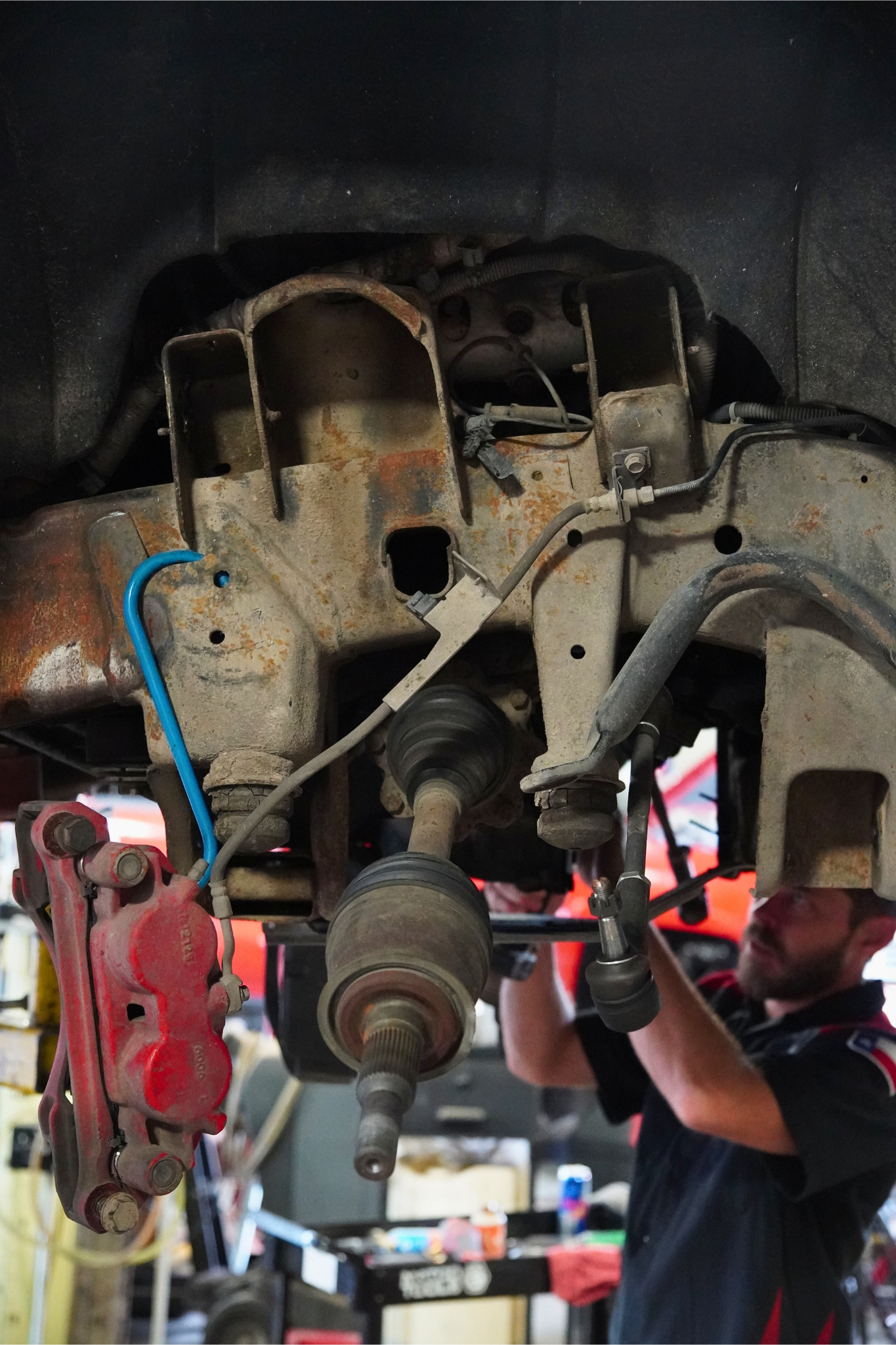 Texas Complete Truck Center Mechanic Inspecting Truck Engine Bay | Texas Complete Truck Center