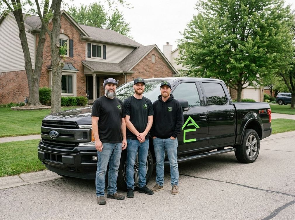 Three men standing in front of a black pickup truck on a suburban street