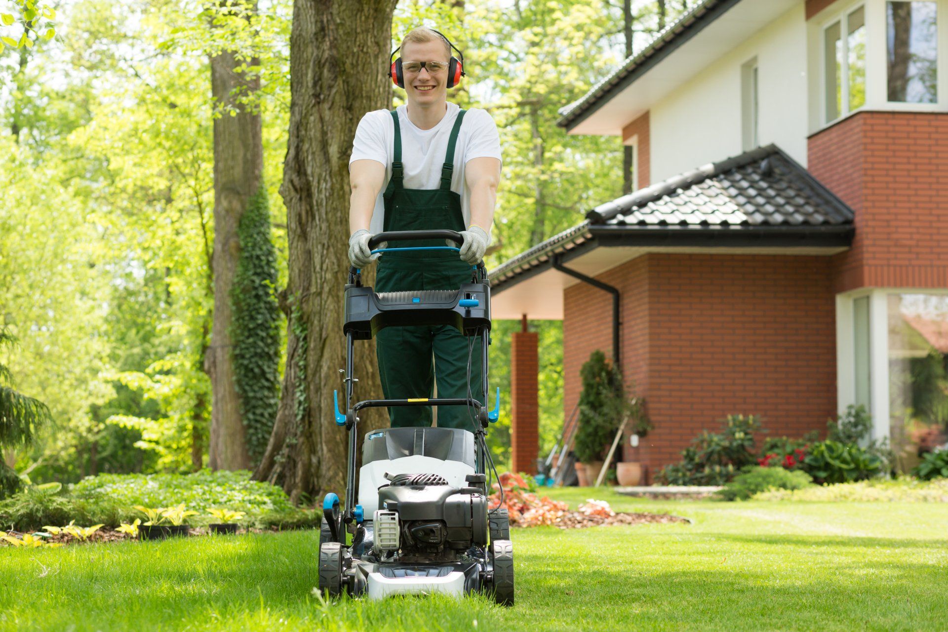 Clicking this image will do nothing man mowing a lawn