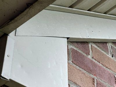 A brick wall with a white trim on it.