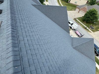An aerial view of a roof with a truck parked on the side of it.