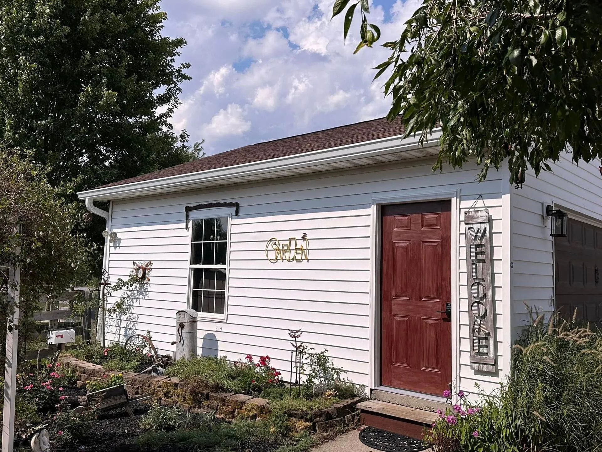 White building with brown door and roof,